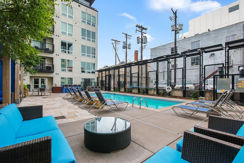 our apartments have a swimming pool with lounge chairs and a table