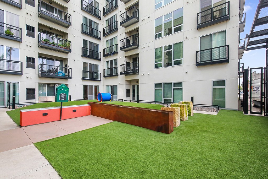 an outdoor play area for children in front of an apartment building