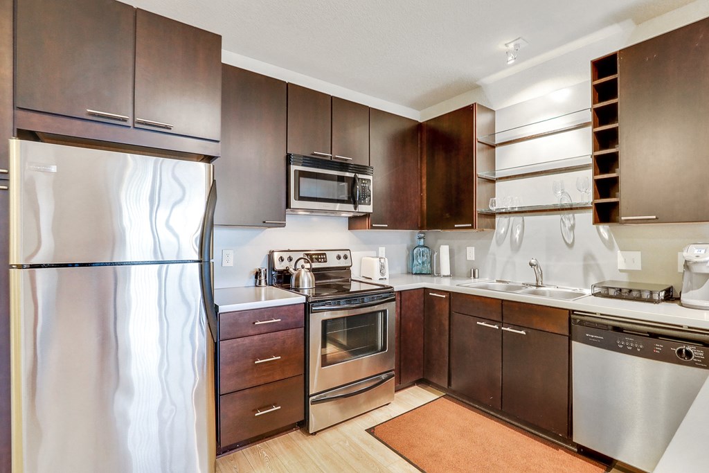 a kitchen with stainless steel appliances and wooden cabinets