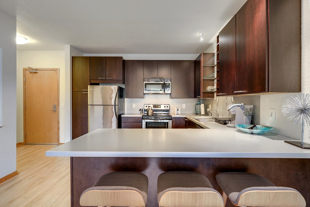 a kitchen with a white island and wooden cabinets