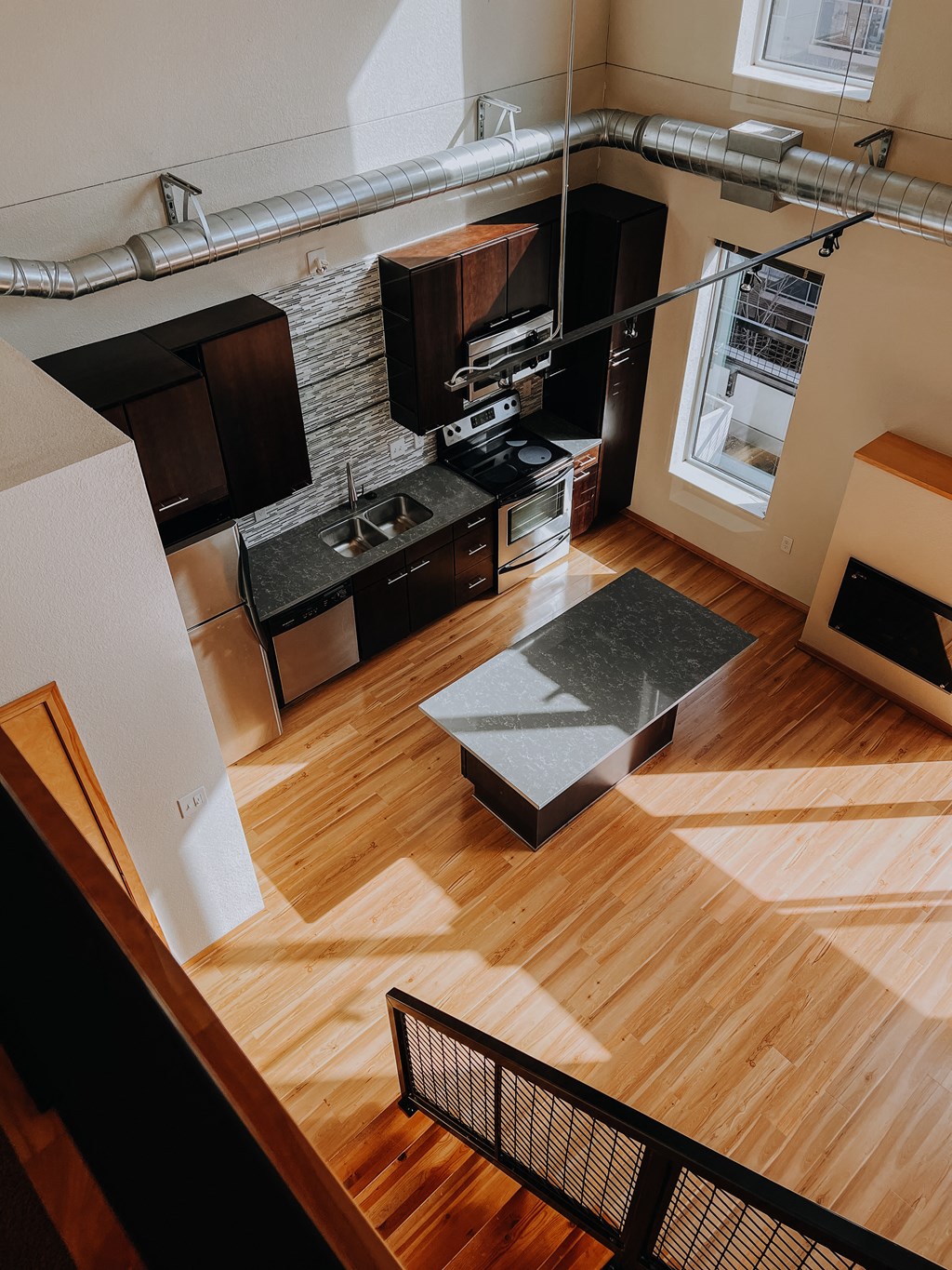 an aerial view of a kitchen and living room from above