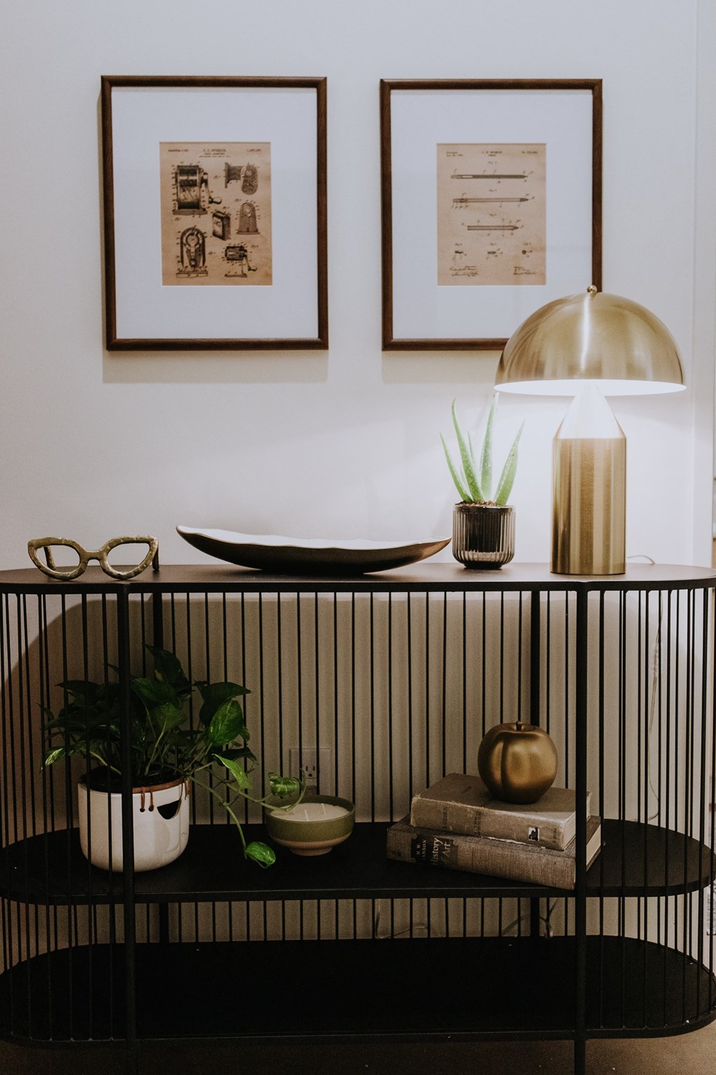 a shelf with various items on it and pictures on the wall