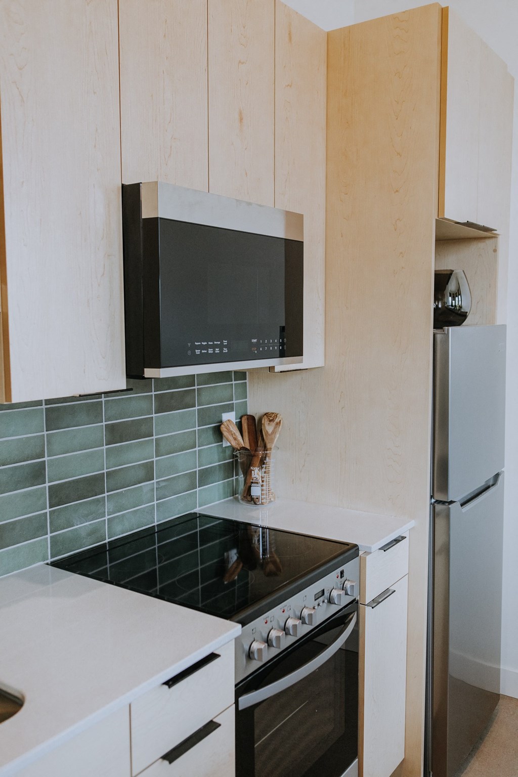 a small kitchen with a stove and a microwave