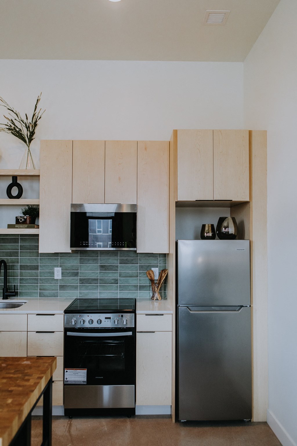 a kitchen with stainless steel appliances and white cabinets