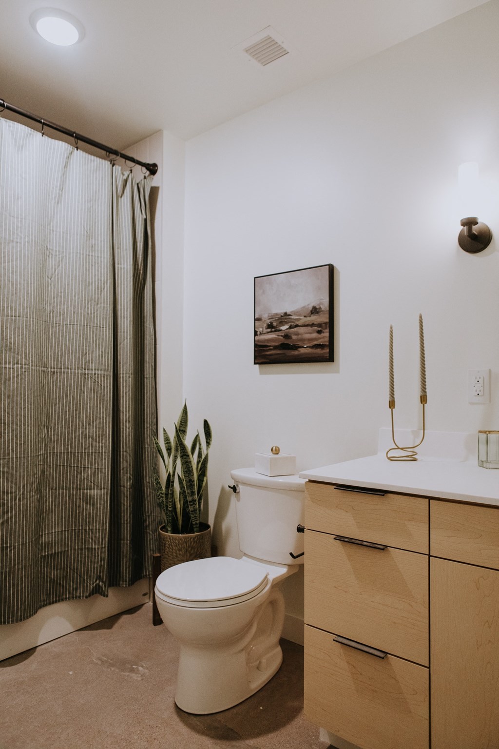 a bathroom with a toilet and a shower and a sink