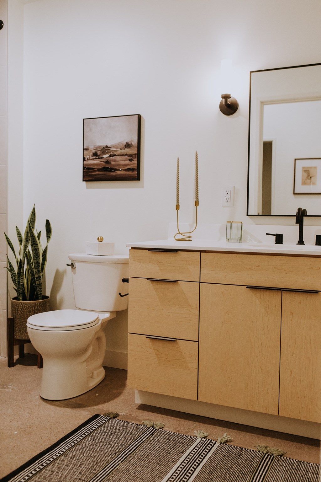a bathroom with a toilet and a sink and a mirror