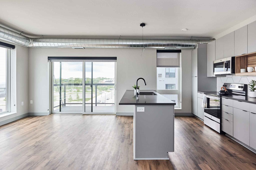 an empty kitchen with a large island in the middle