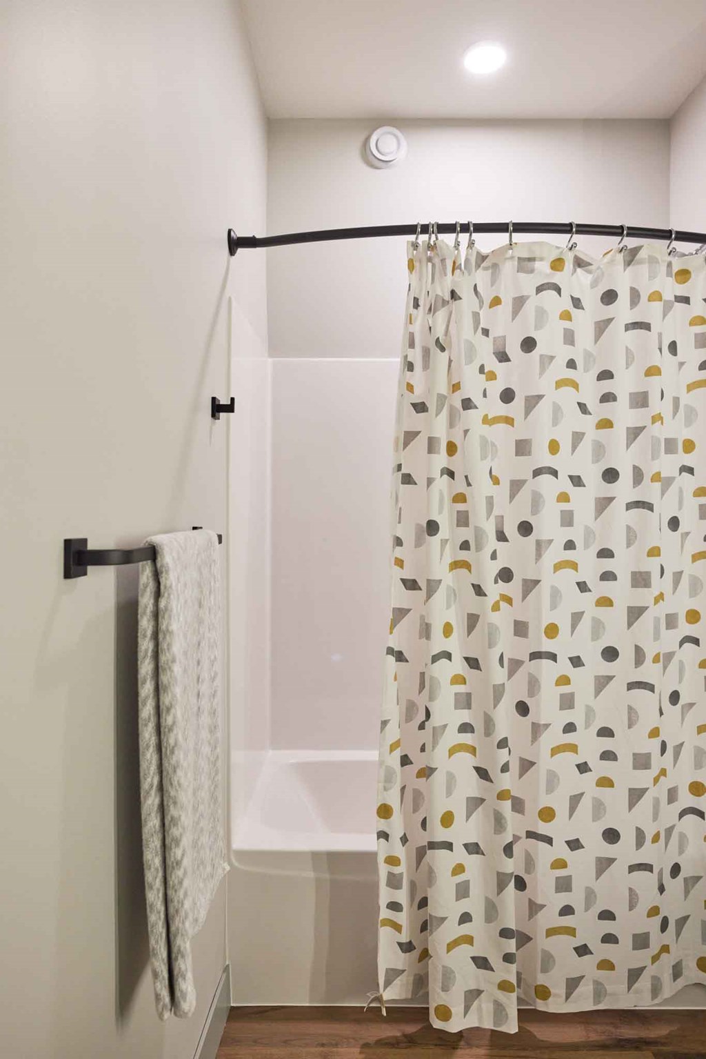 a bathroom with a shower curtain and a bath tub