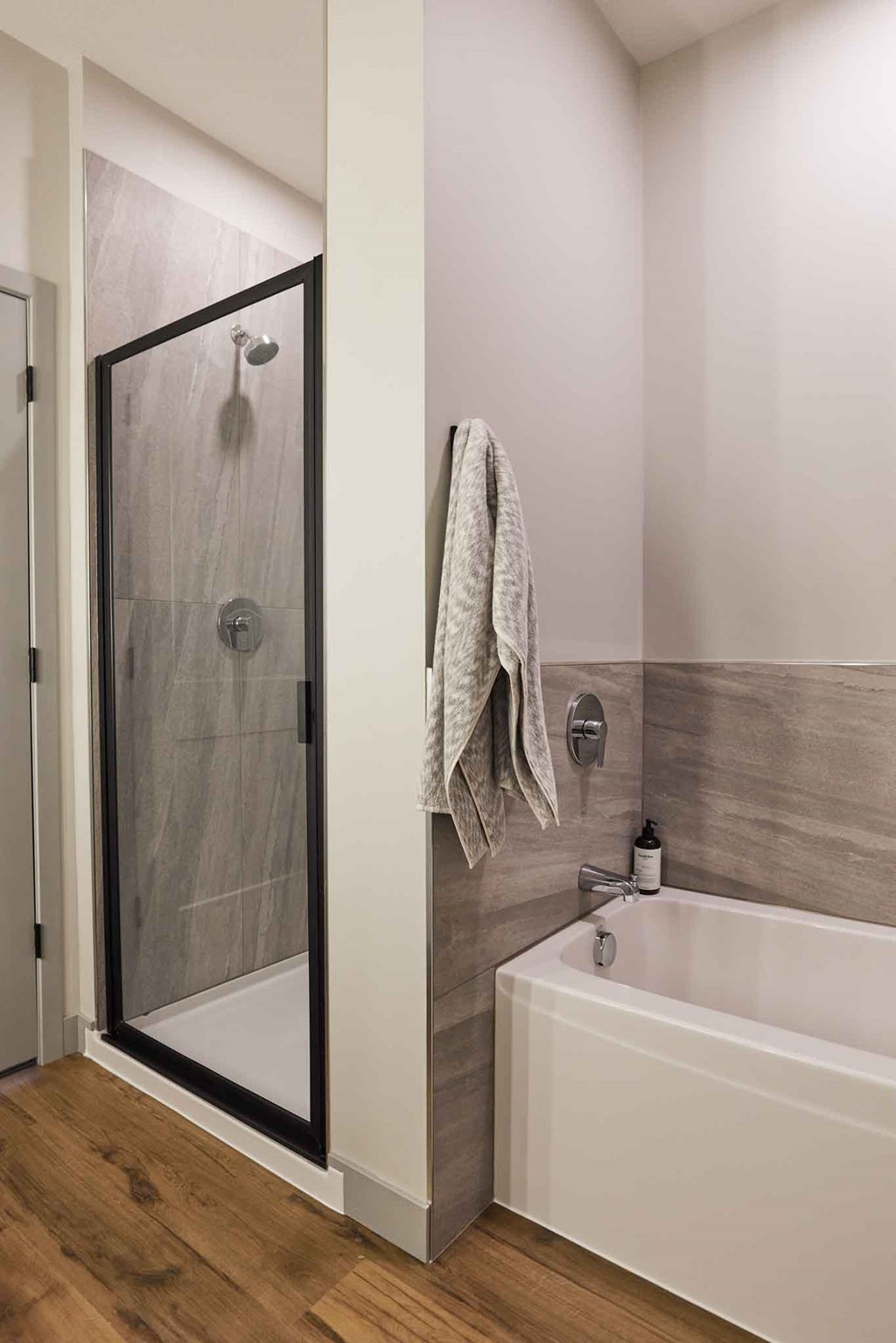 a bathroom with a shower and a tub and a sink