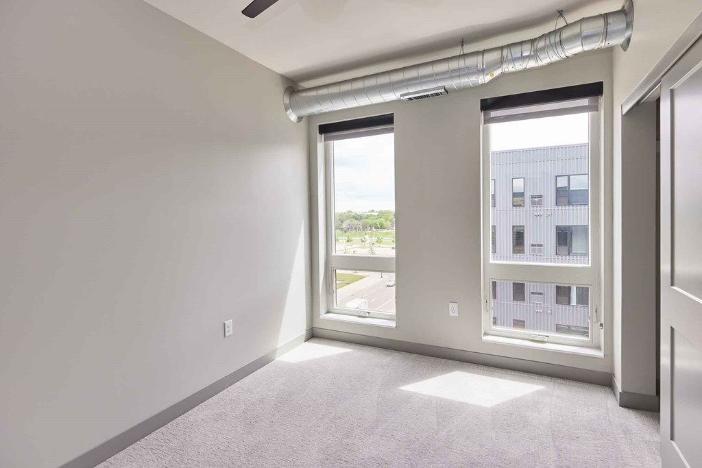 an empty living room with a large window