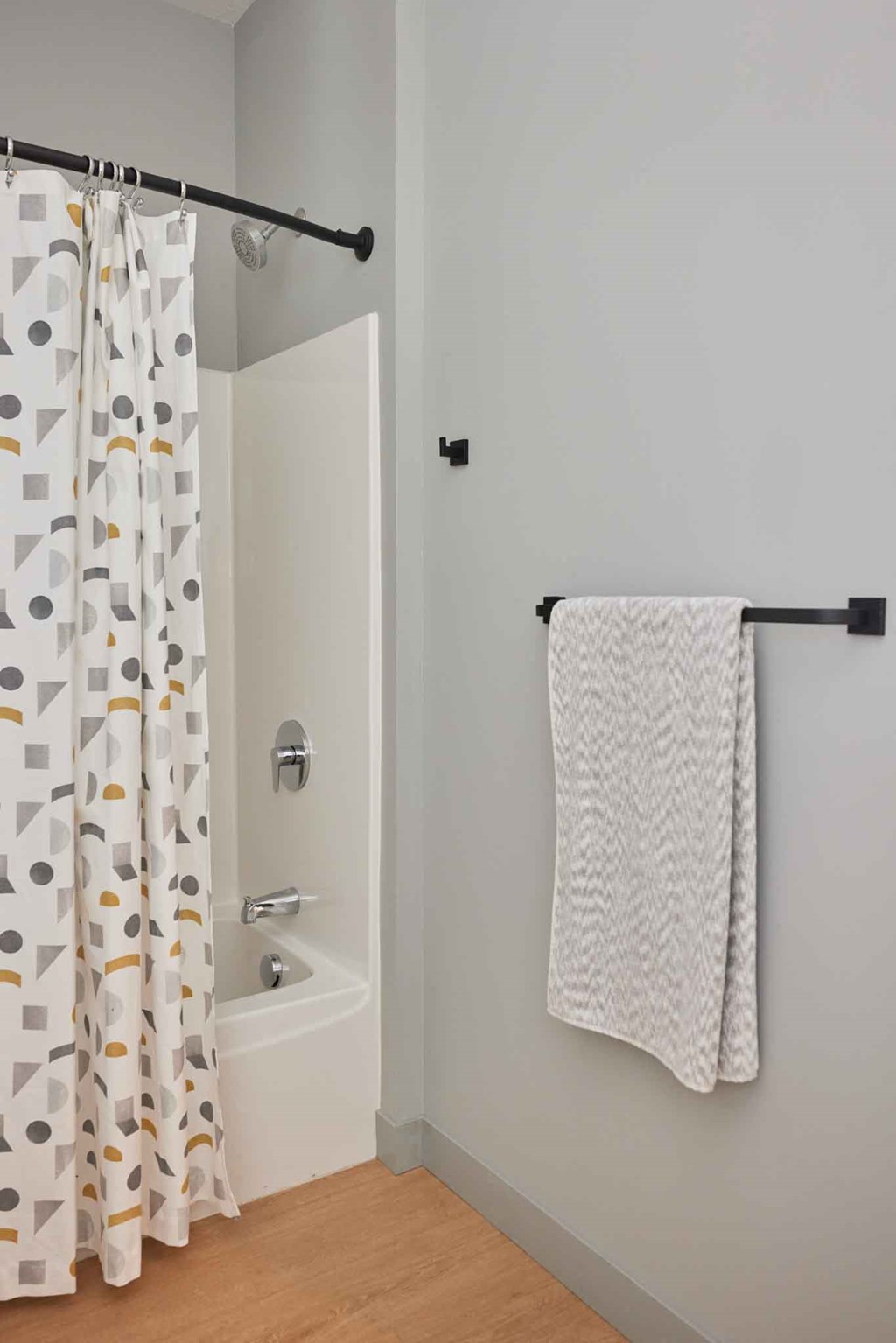 a bathroom with a shower curtain and a white tub