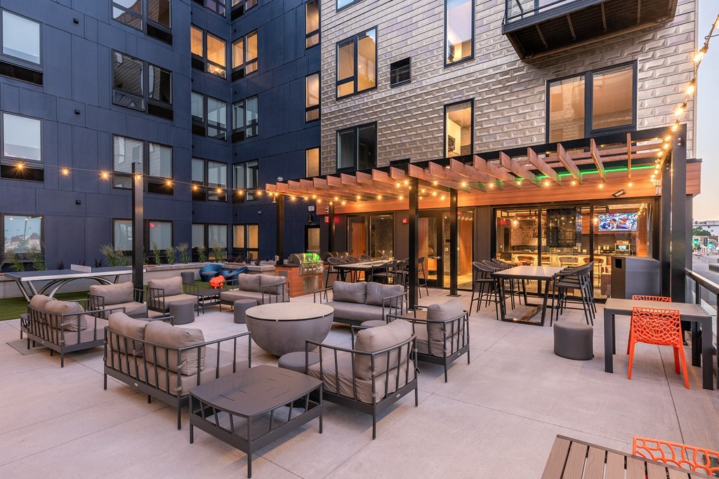 an outdoor patio area of a building with tables and chairs