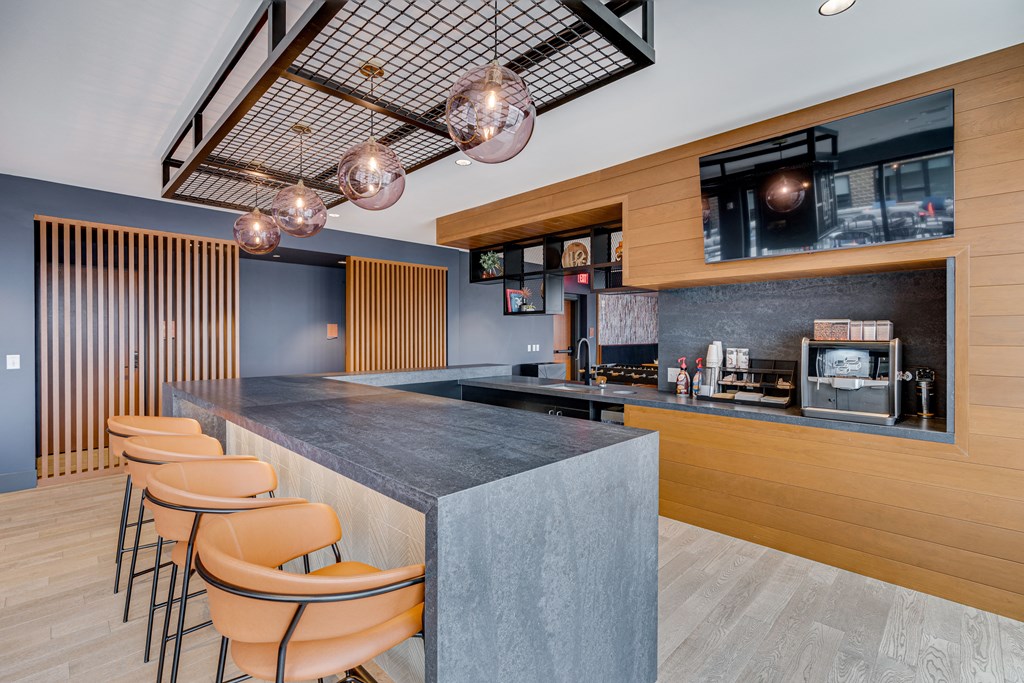 a kitchen with a counter top and chairs