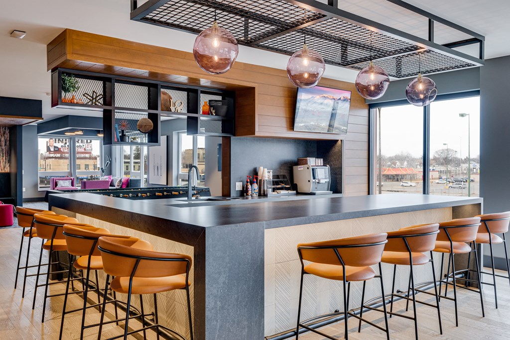 the bar area of a restaurant with bar stools