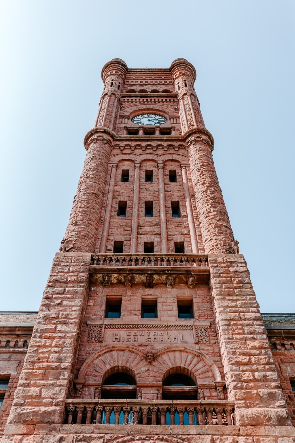 a tall brick tower with a clock on the top of it