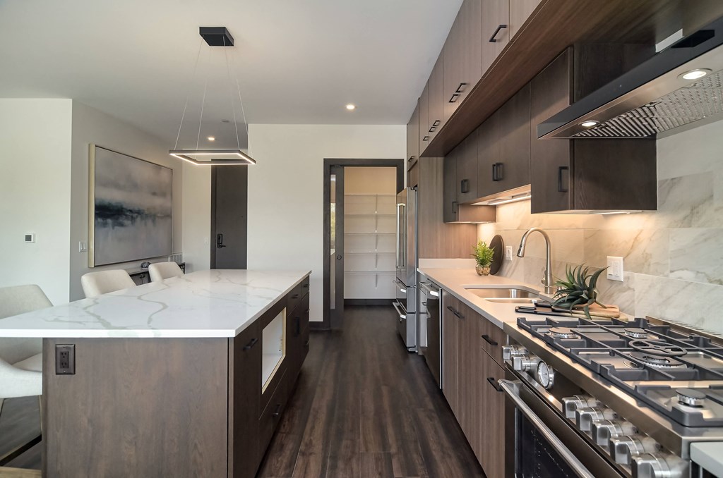 a kitchen with a marble counter top and a stove