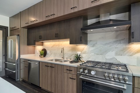 a kitchen with stainless steel appliances and wooden cabinets