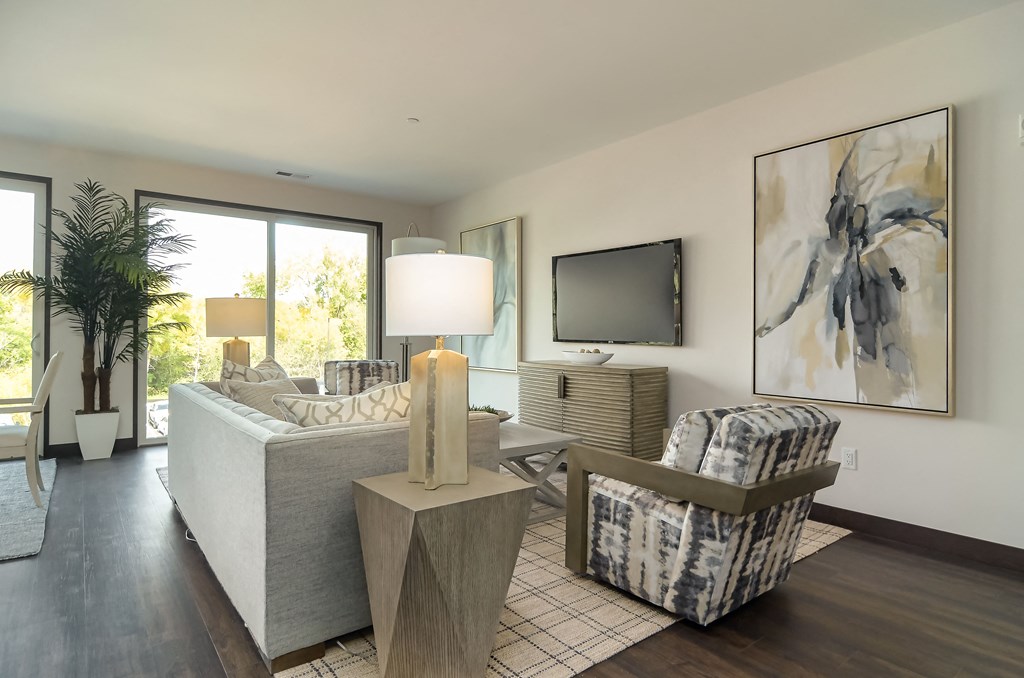 a living room with a couch and chairs and a television