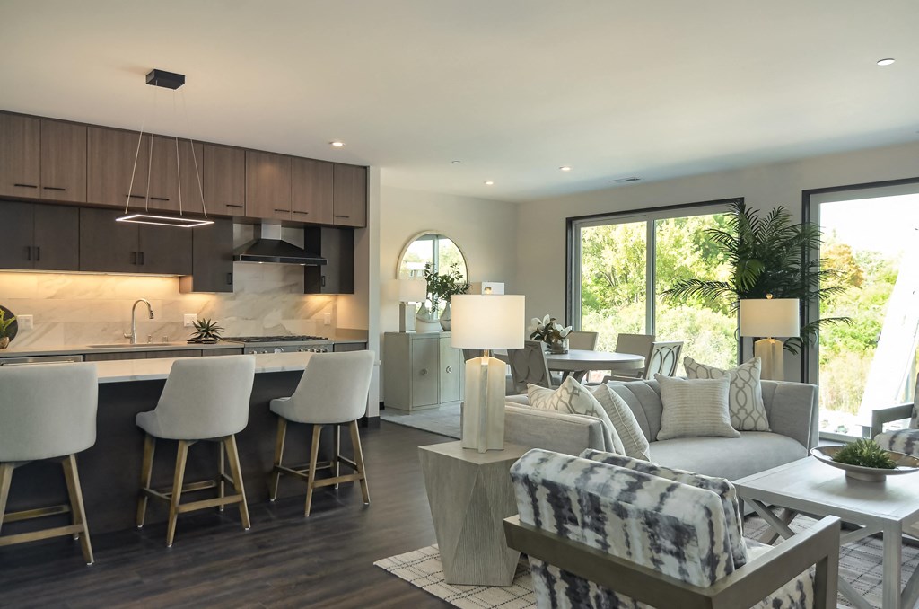 a large living room with a kitchen and dining area