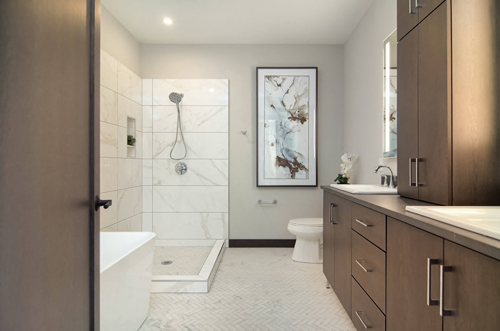 a bathroom with a shower and a toilet and a sink