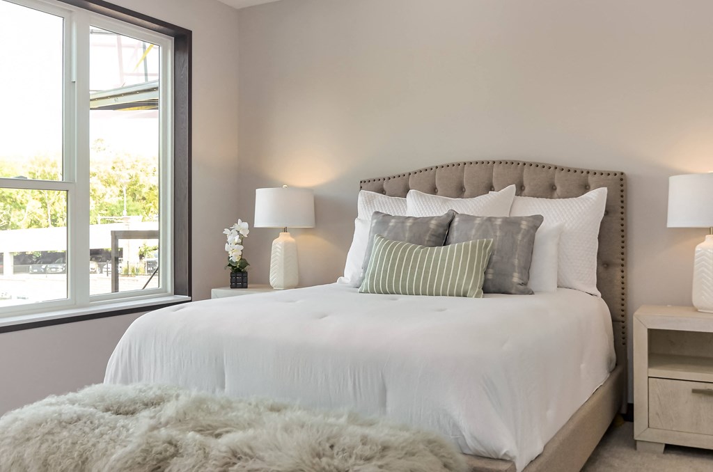 a bedroom with a large bed and a large window