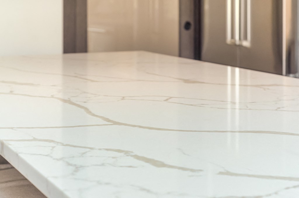 a white marble counter top in a kitchen