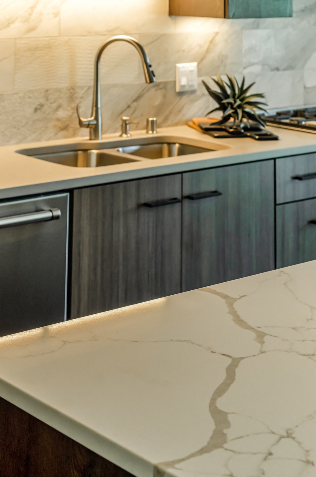 a kitchen with marble counter tops and a sink