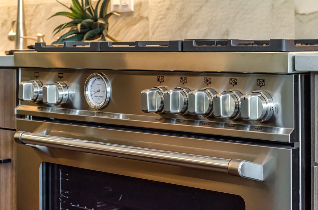 a close up of a stove top oven with a clock on it