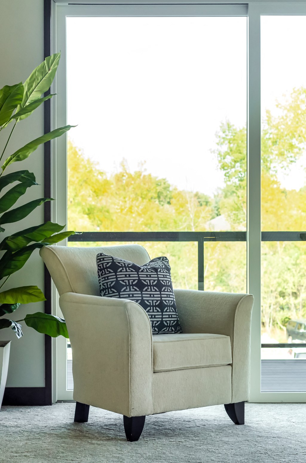 a chair with a pillow in front of a window