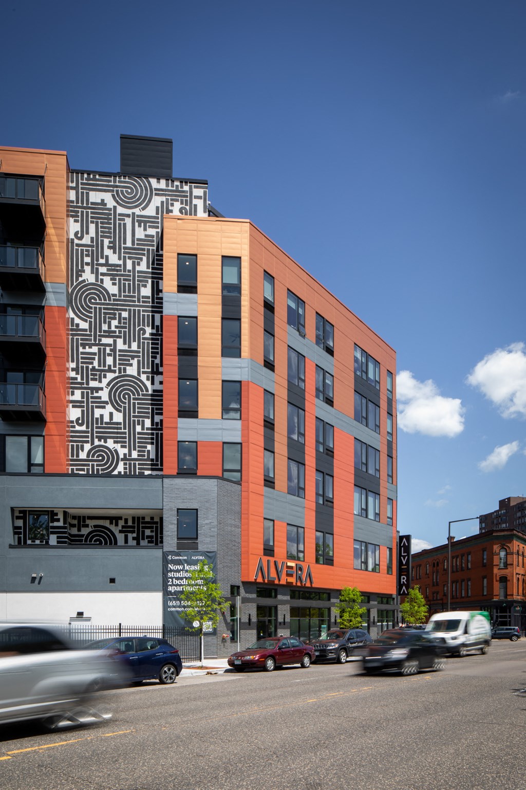 a large building with a mural on the side of a city street