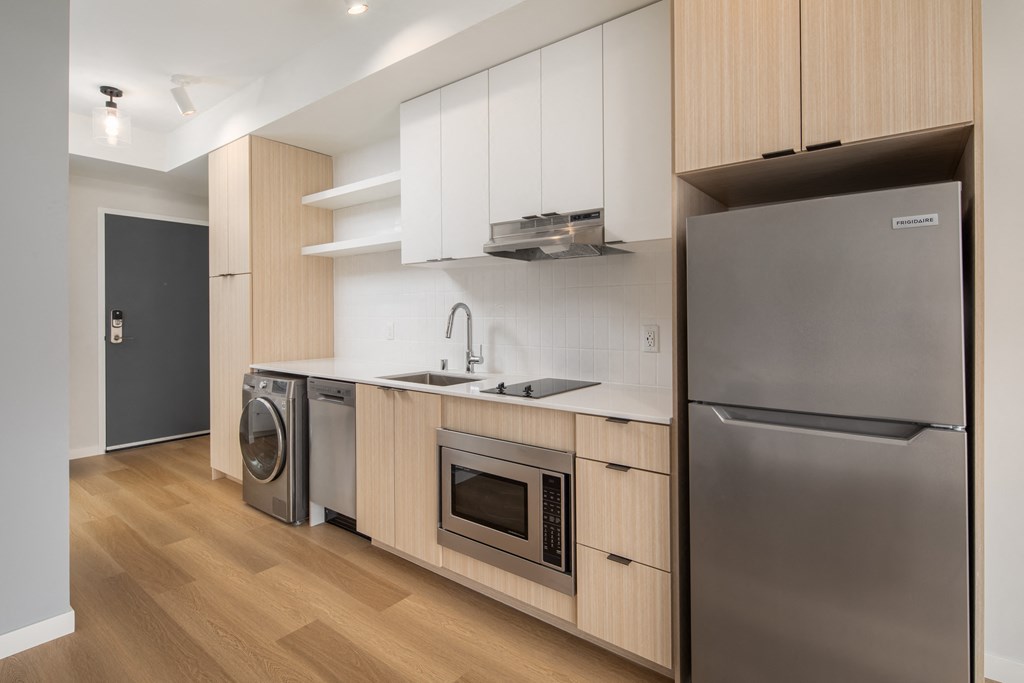 a kitchen with wooden cabinets and stainless steel appliances