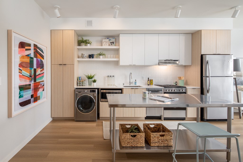 a kitchen with a island and stainless steel appliances