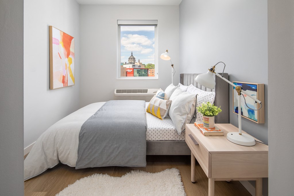 a bedroom with a bed and a window