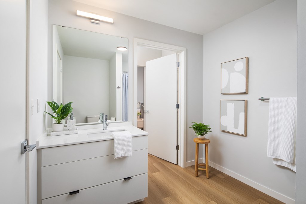 a white bathroom with a sink and a mirror