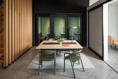 a dining room with a table and chairs in front of a door