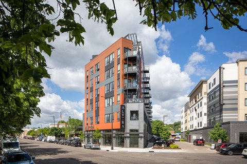 a large orange building with a fire escape on a city street
