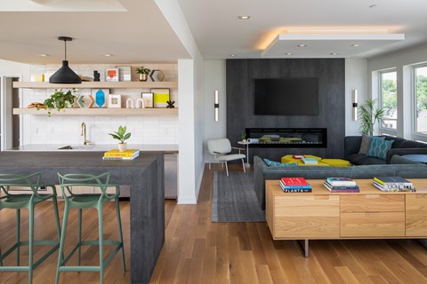 a living room with a couch and a kitchen with a table and chairs