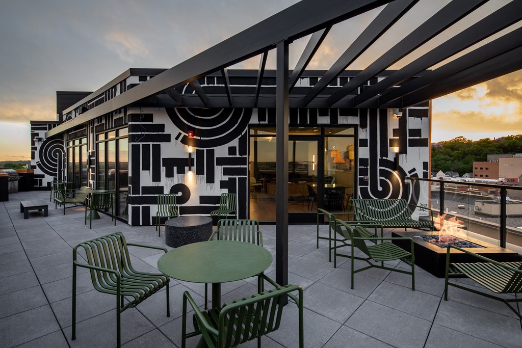 a rendering of a patio with green tables and chairs