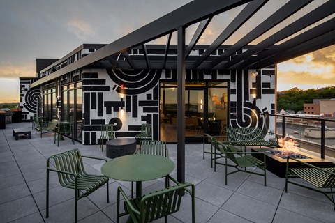 a rendering of a patio with green tables and chairs