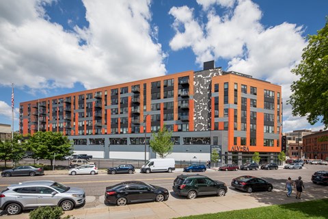 a large orange building with cars parked in front of it