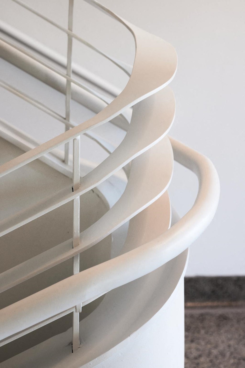 a spiral staircase in a white building with white railings