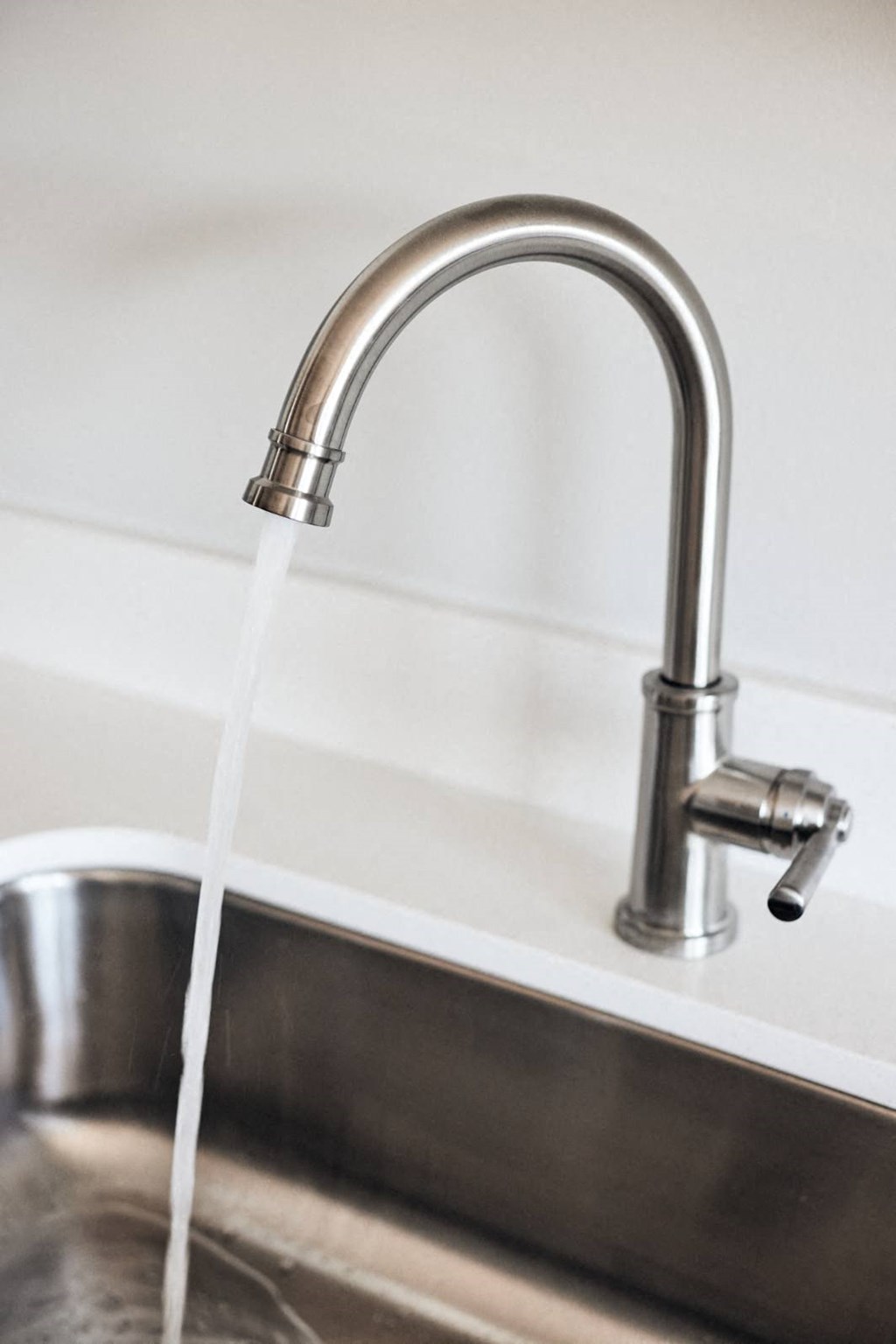 a kitchen sink with water coming out of a faucet