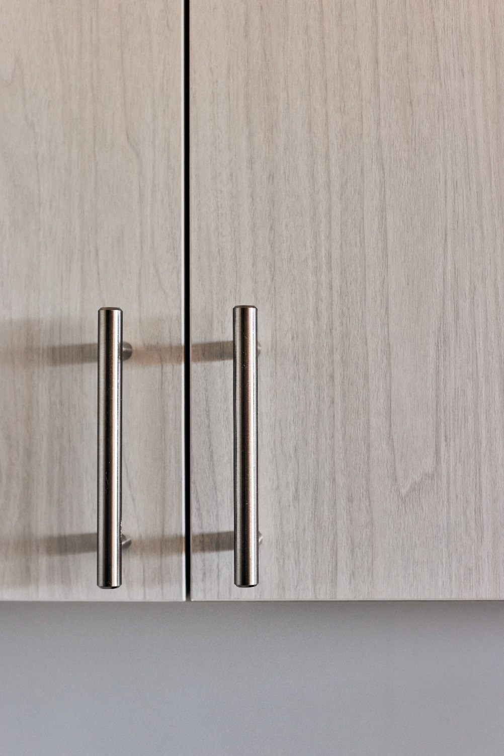 a close up of a cabinet door with a metal handle