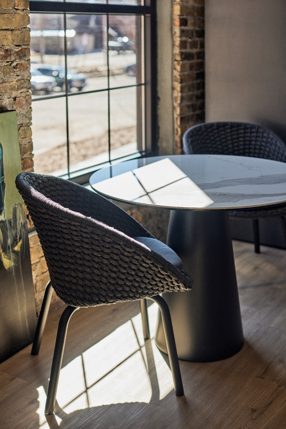 a table and chairs next to a window in a restaurant
