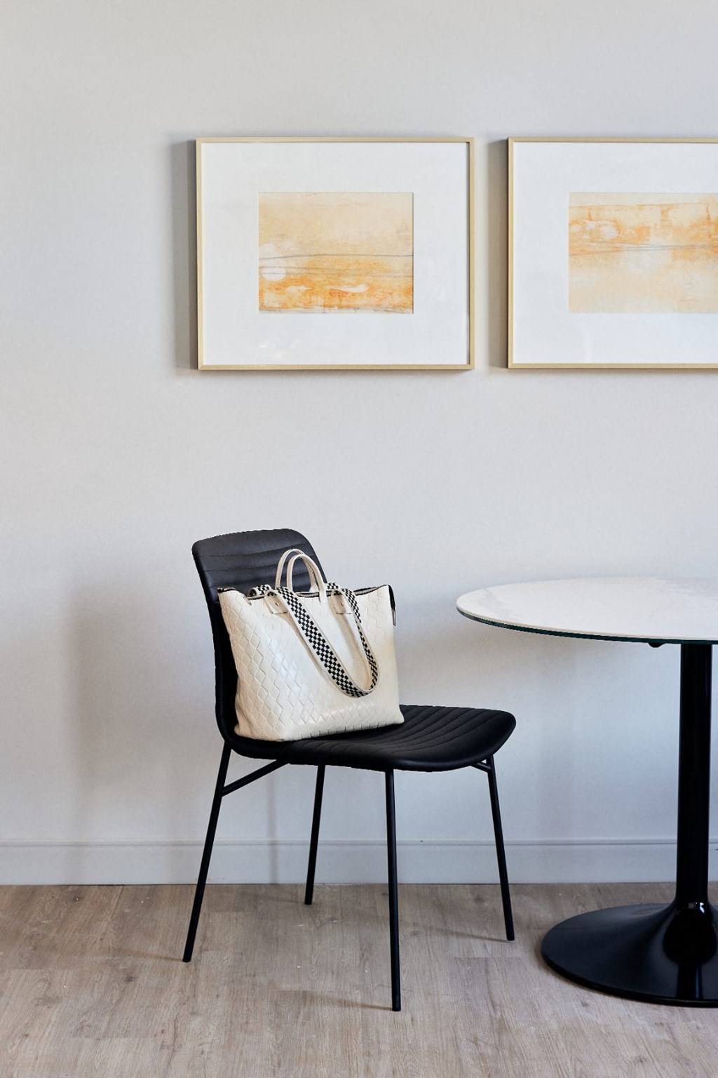 a black chair with a purse and a table
