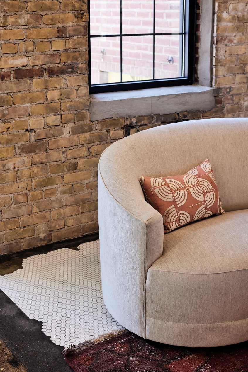 a chair with a pillow in front of a window