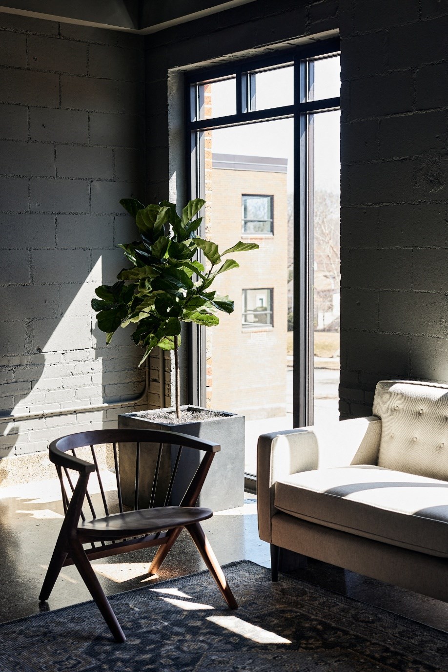 a living room with a chair and a window