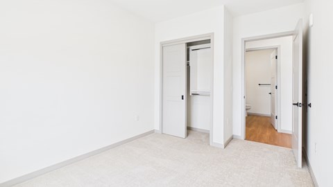 A white room with two doors, one open and one closed.