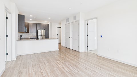 A kitchen with a bar counter and a dining table.
