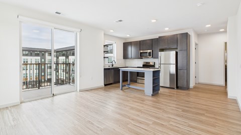 A kitchen with a refrigerator, microwave, and oven is shown.